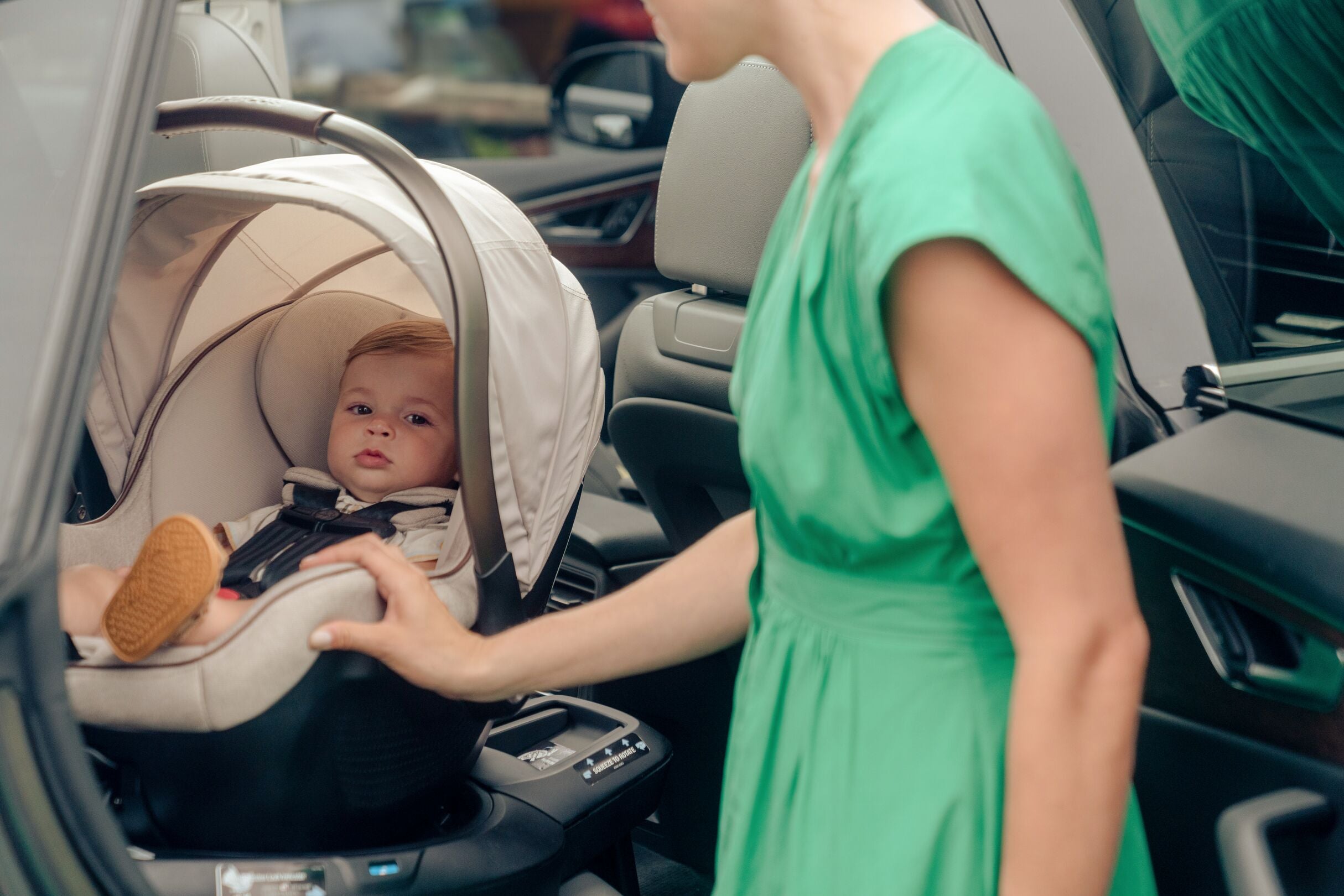 mother beside baby in infant car seat