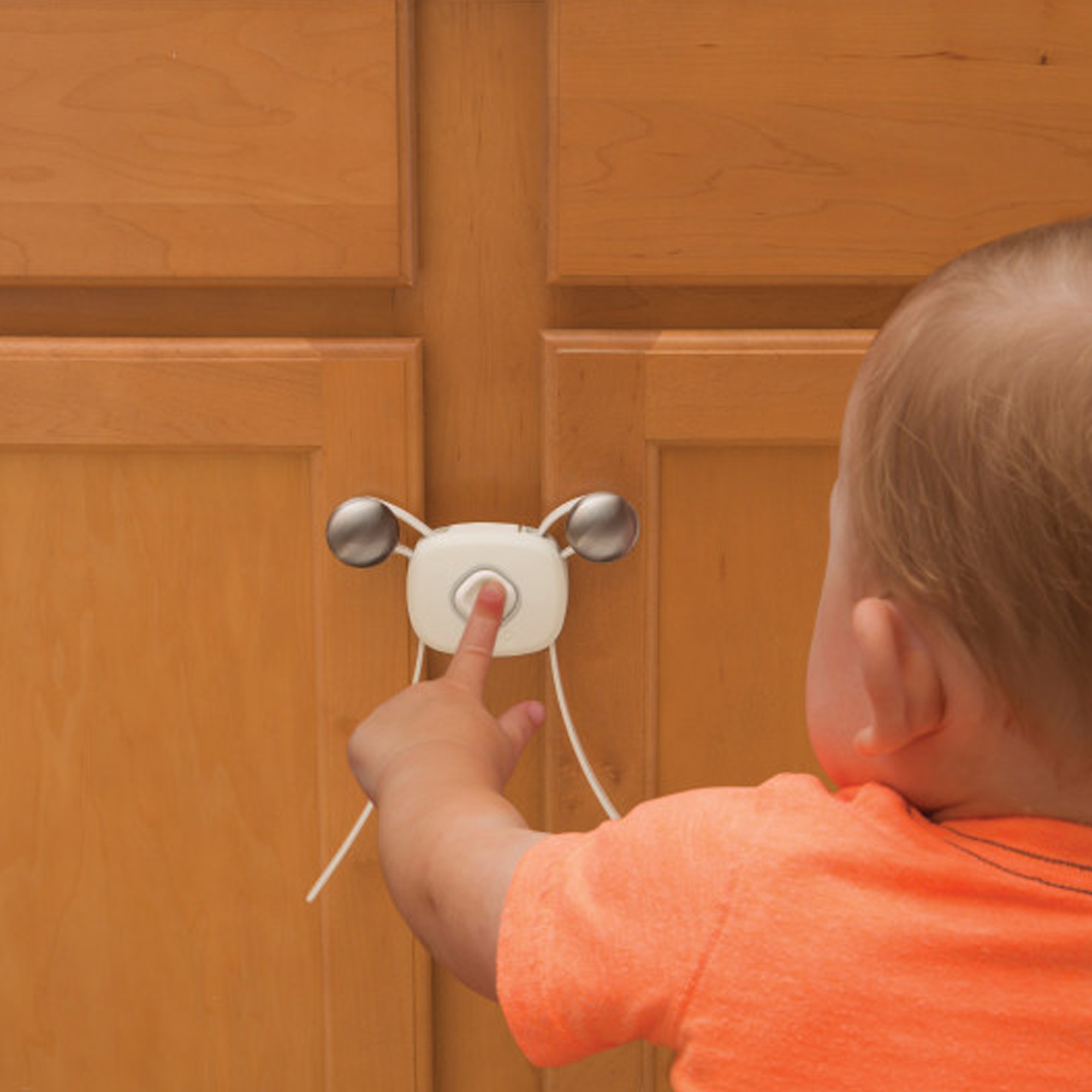 baby touching cabinet door secured shut with safety lock
