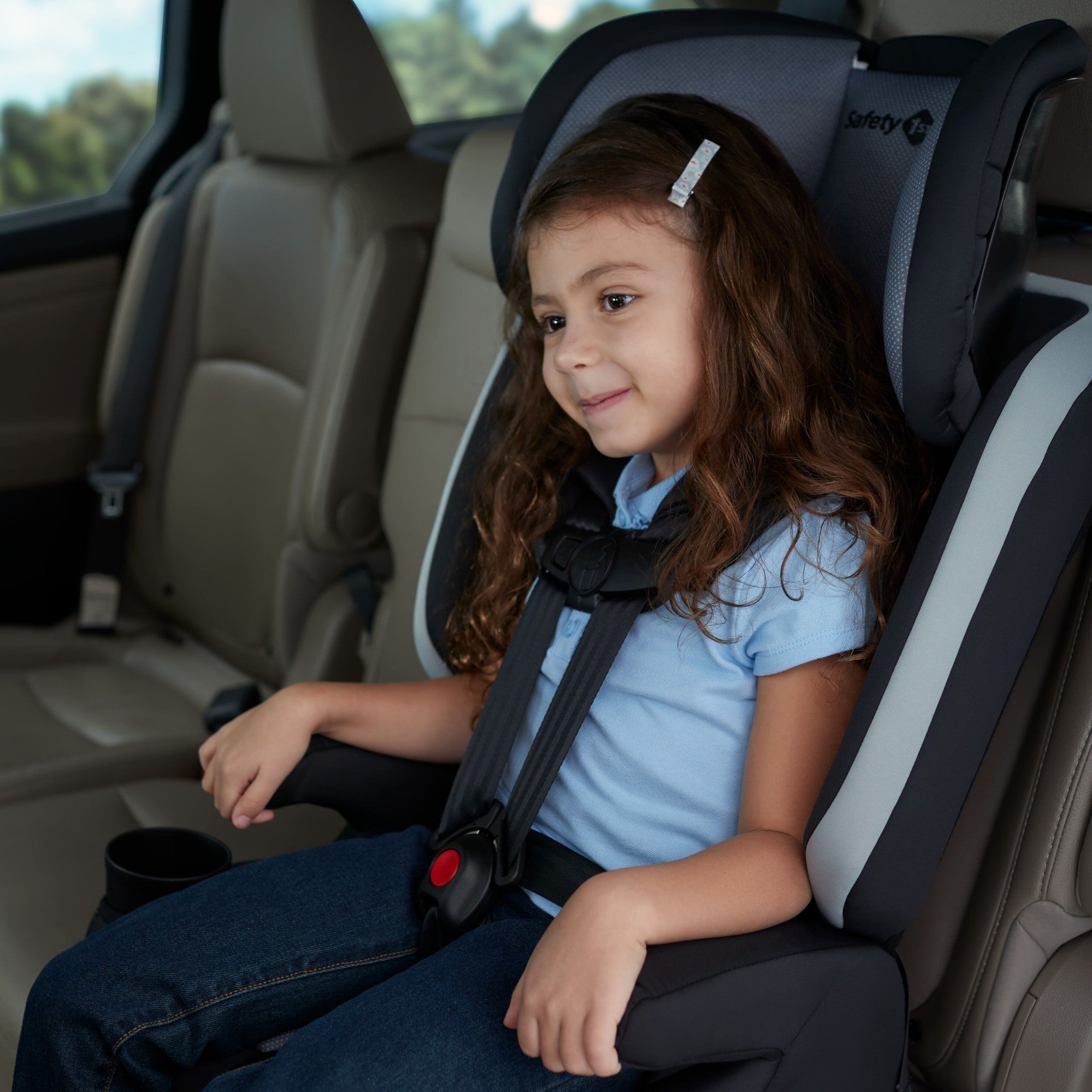 Boost-and-Go All-in-One Harness Booster Car Seat - Dunes Edge - smiling girl strapped into backless booster
