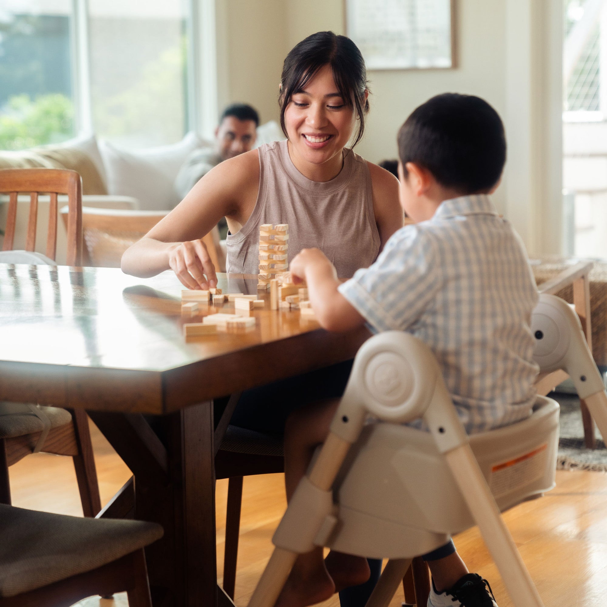 Minla 6-In-1 High Chair - child and mother playing a game while child sits in high chair