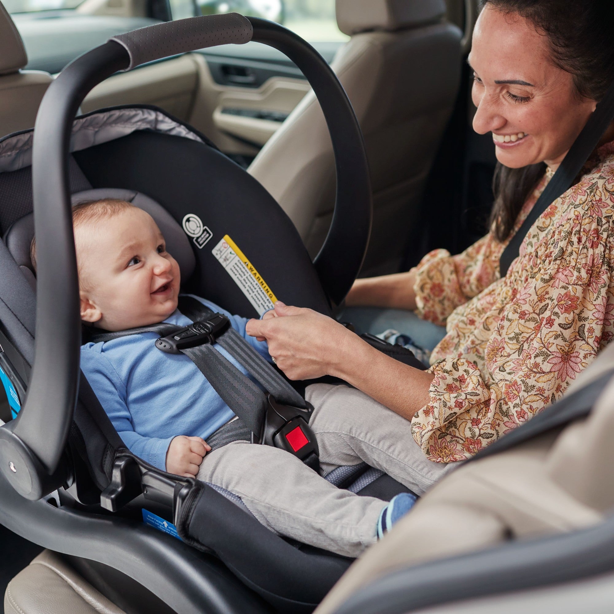 onBoard™35 SecureTech™ Infant Car Seat - mother gazing at smiling infant in seat