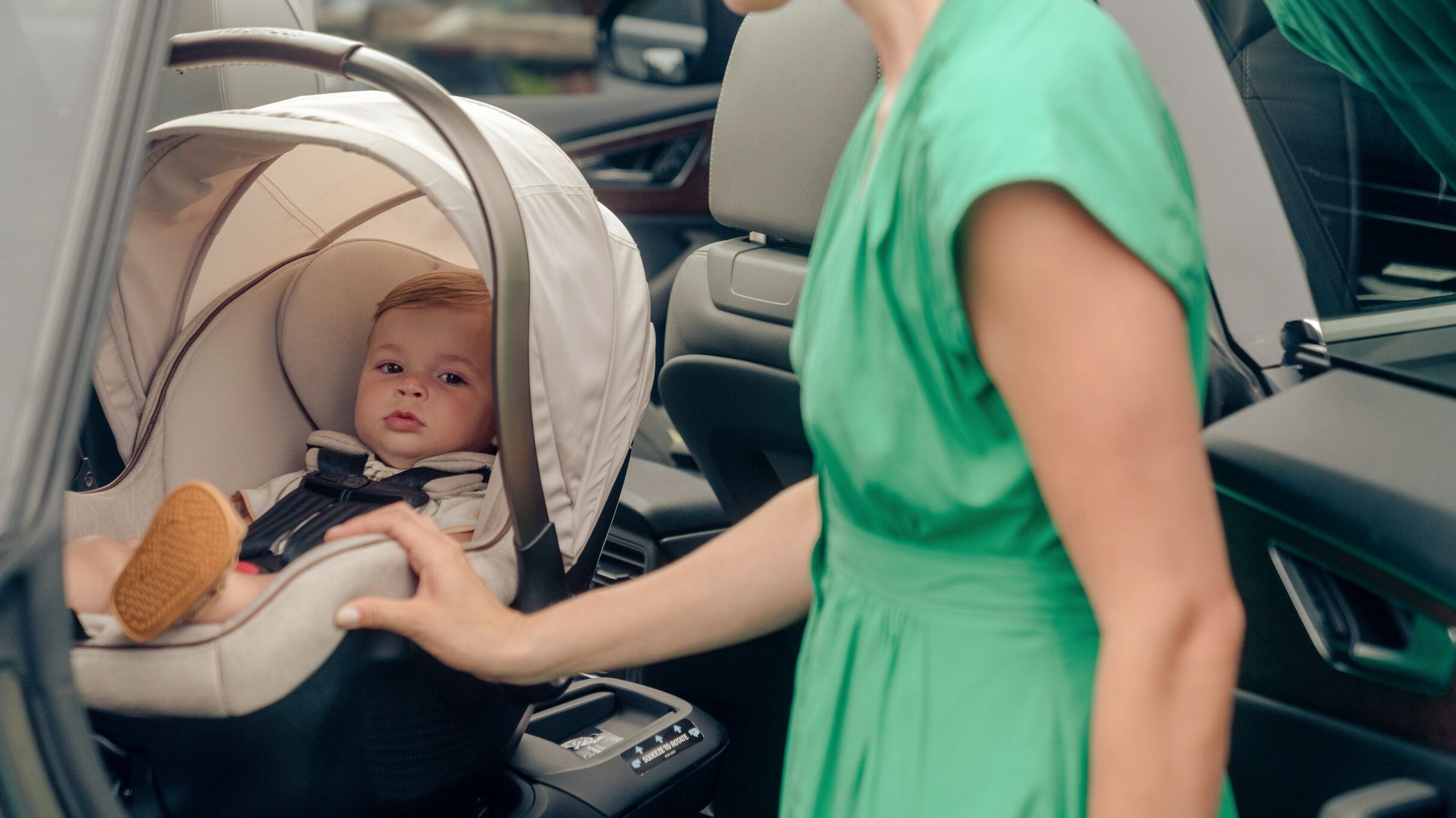 mother beside baby in infant car seat
