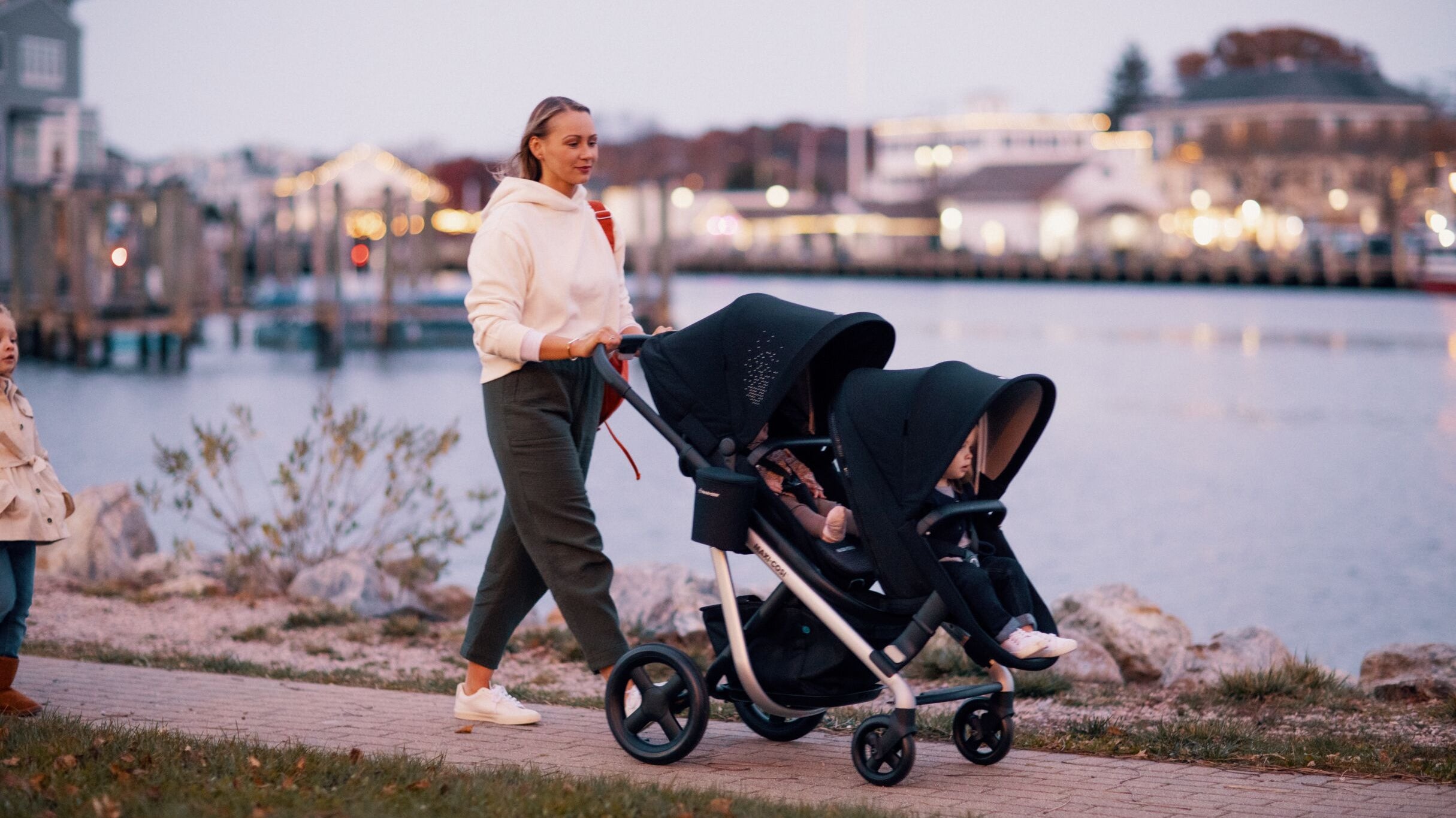 mother walking with babies in two strollers