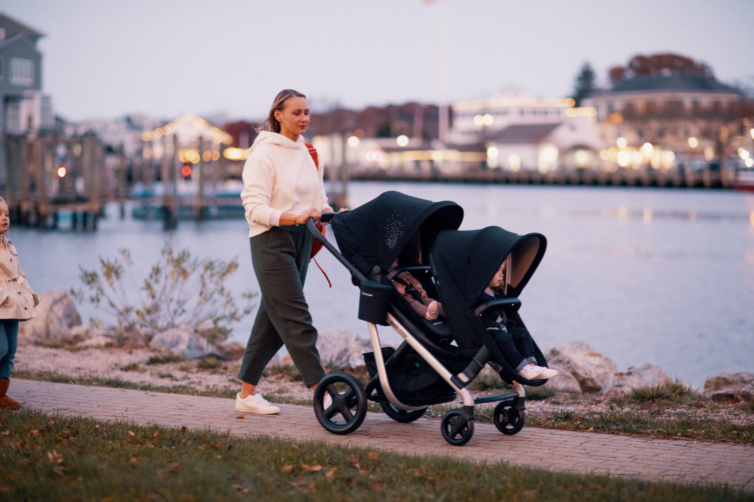 mother walking with babies in two strollers