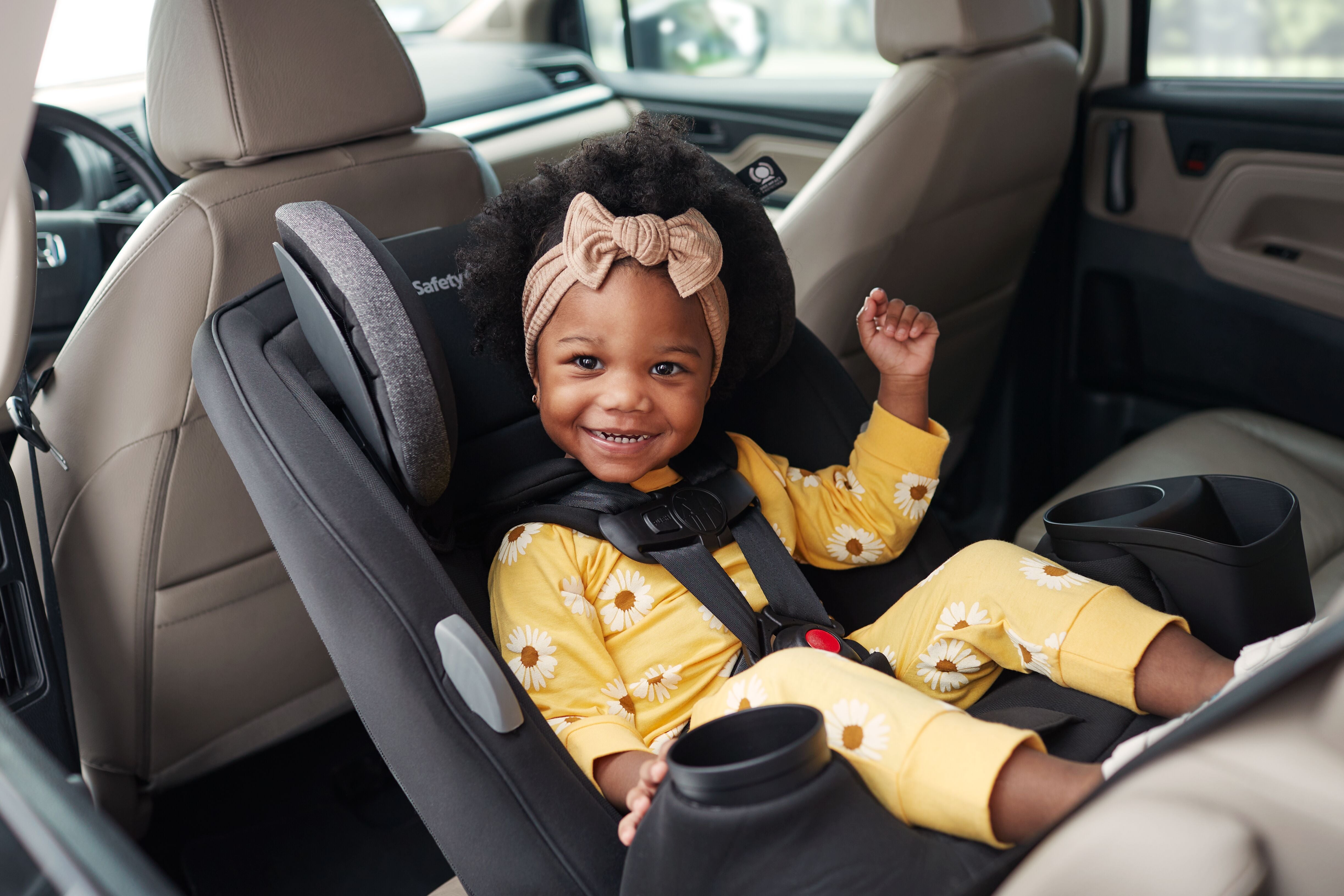 baby smiling in rear-facing infant car seat