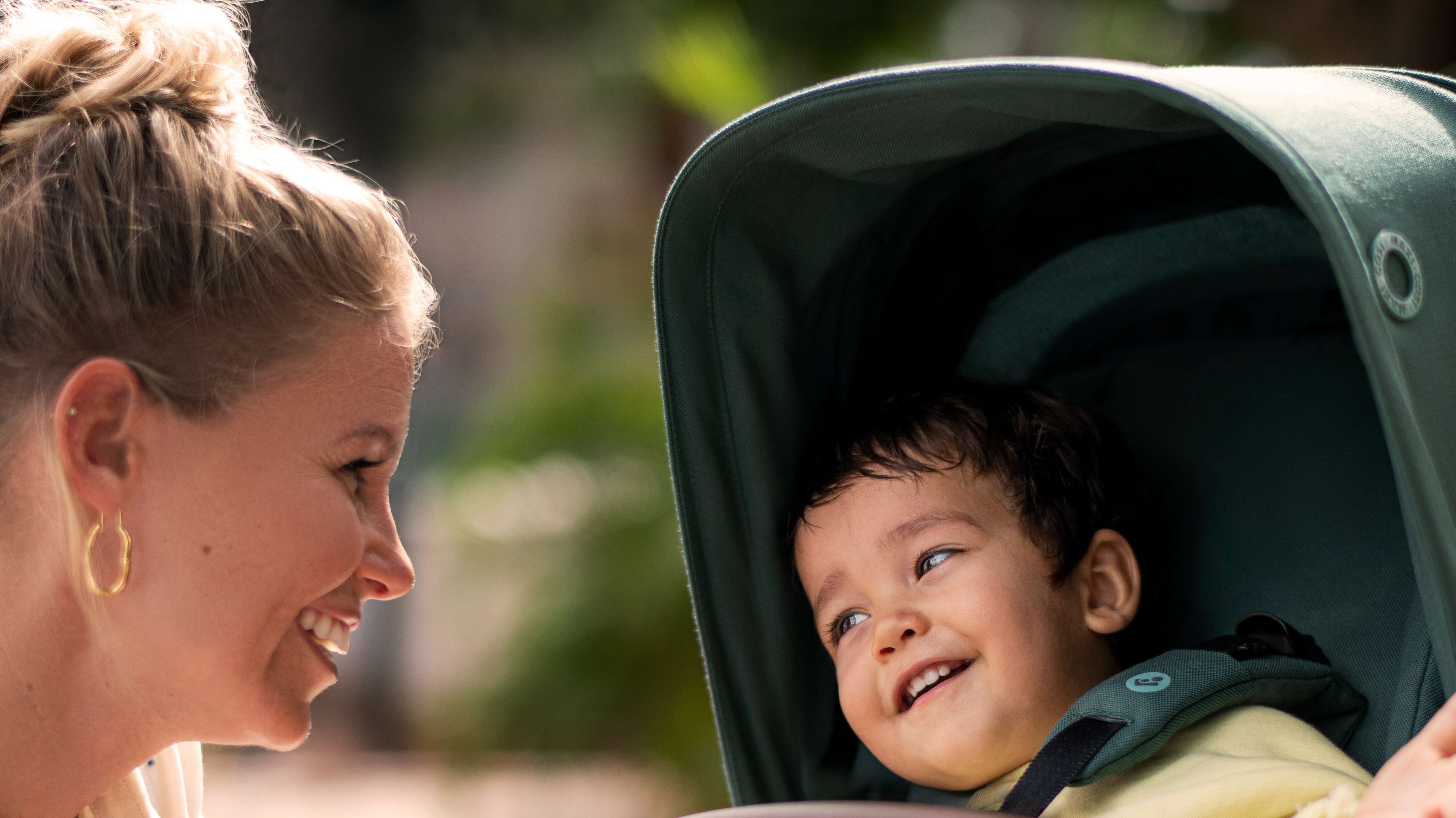 mother smiling at child in stroller