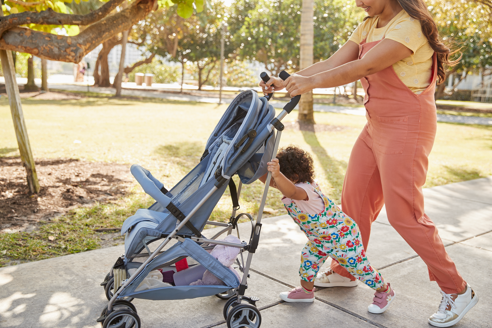 mother and child pushing Simple Fold Compact Stroller