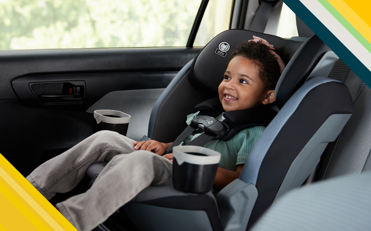 child smiling in her car seat