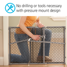 Parent demonstrating baby gate no drilling or tools necessary with pressure mount design.