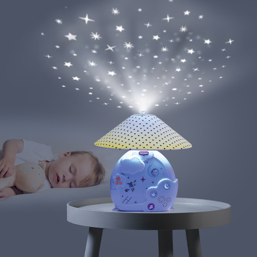 Magical Night 3-in-1 Projector Mobile - toddler sleeping beside mobile, which is shown projecting stars onto ceiling