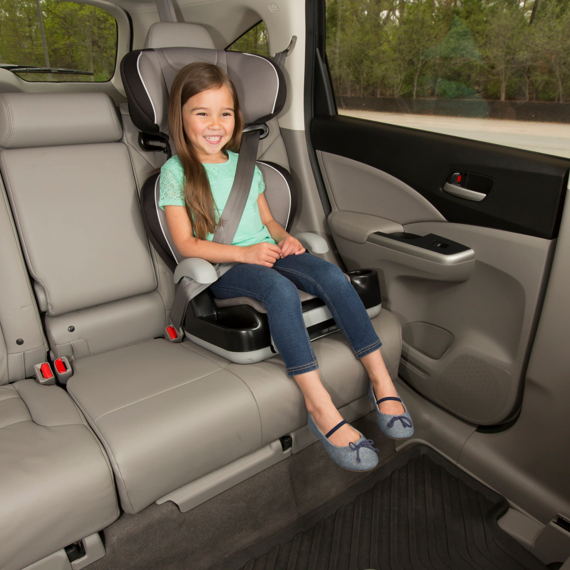 Store 'n Go Sport Booster Car Seat - Telluride - girl smiling in seat