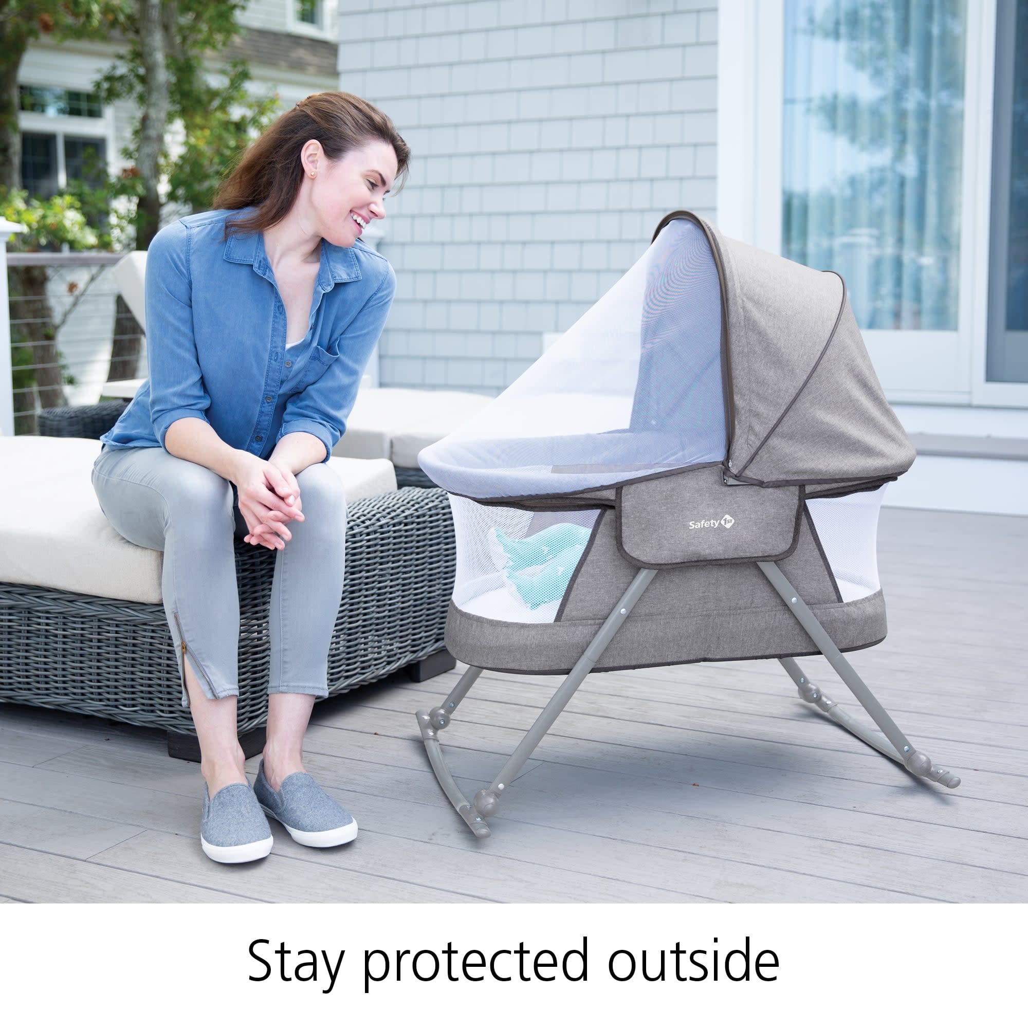 Parent on a back porch showing how the bug screen helps her baby stay protected outside