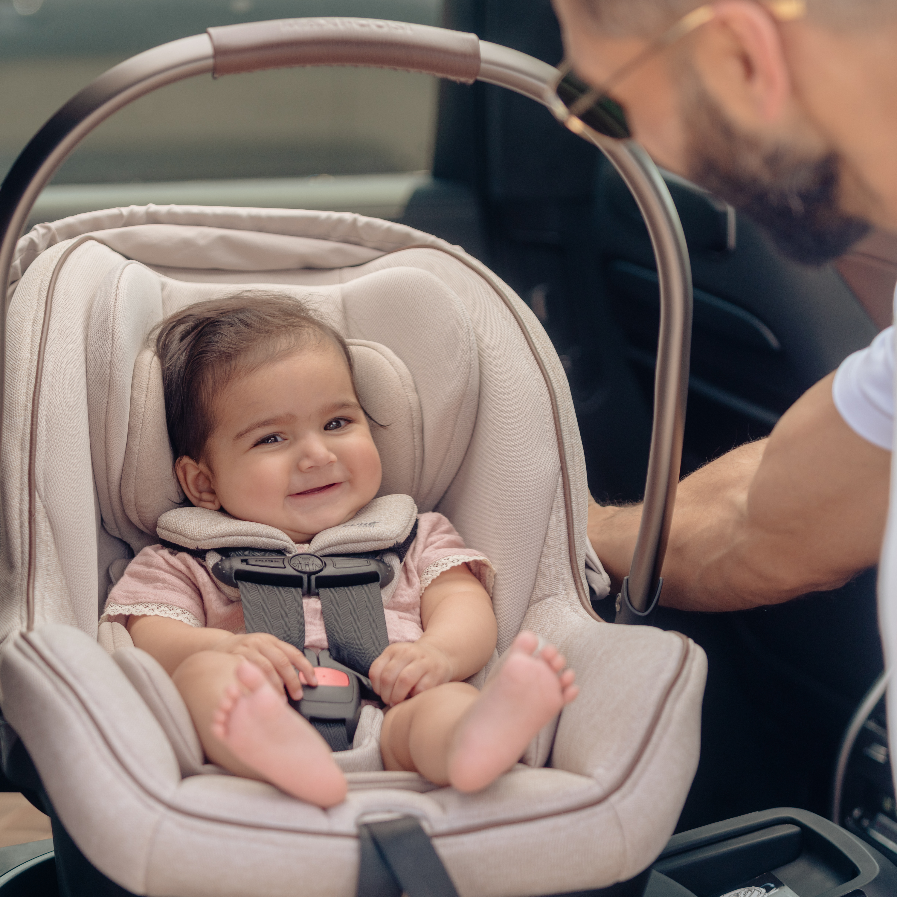 baby smiling in infant car seat