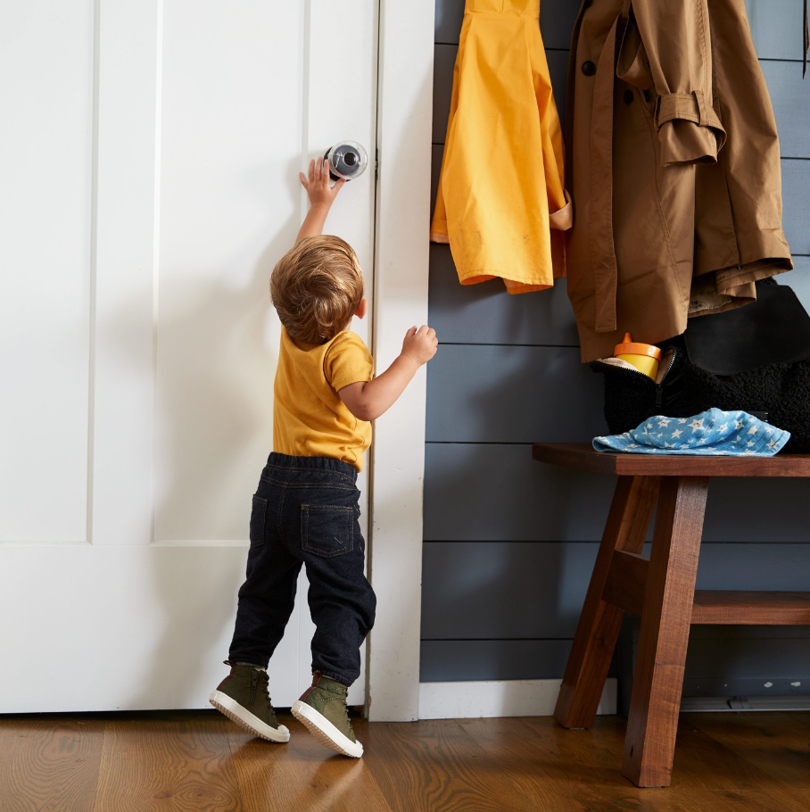 Kid reaching for protected door knob