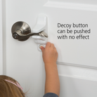Child pushing decoy button on latch with no effect.