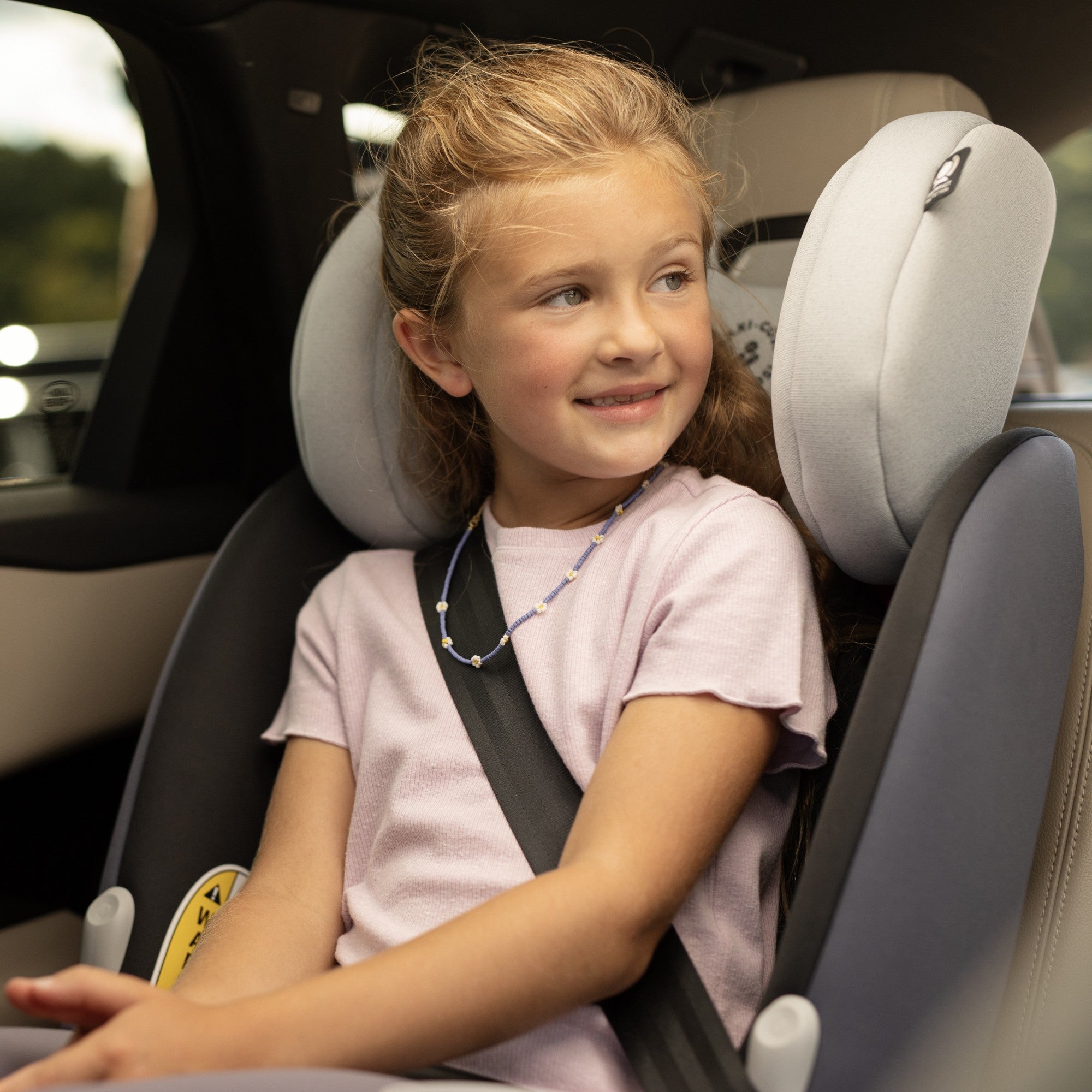 Pria™ All-in-One Convertible Car Seat - girl in car seat smiling and looking out the window