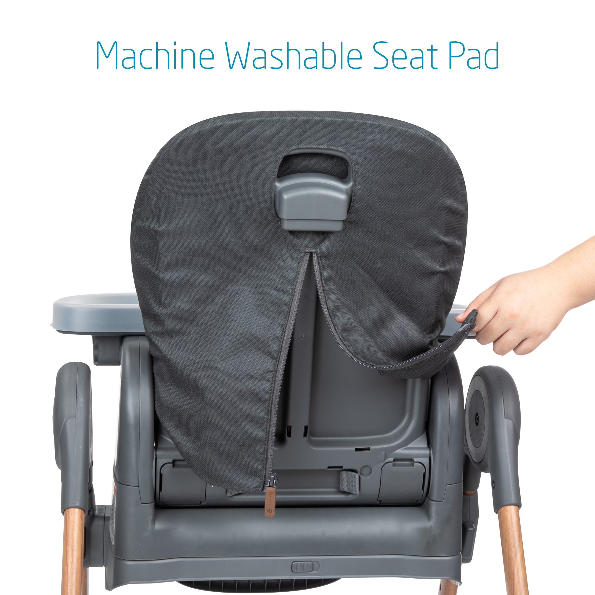 Parent demonstrating machine washable seat pad on high chair.