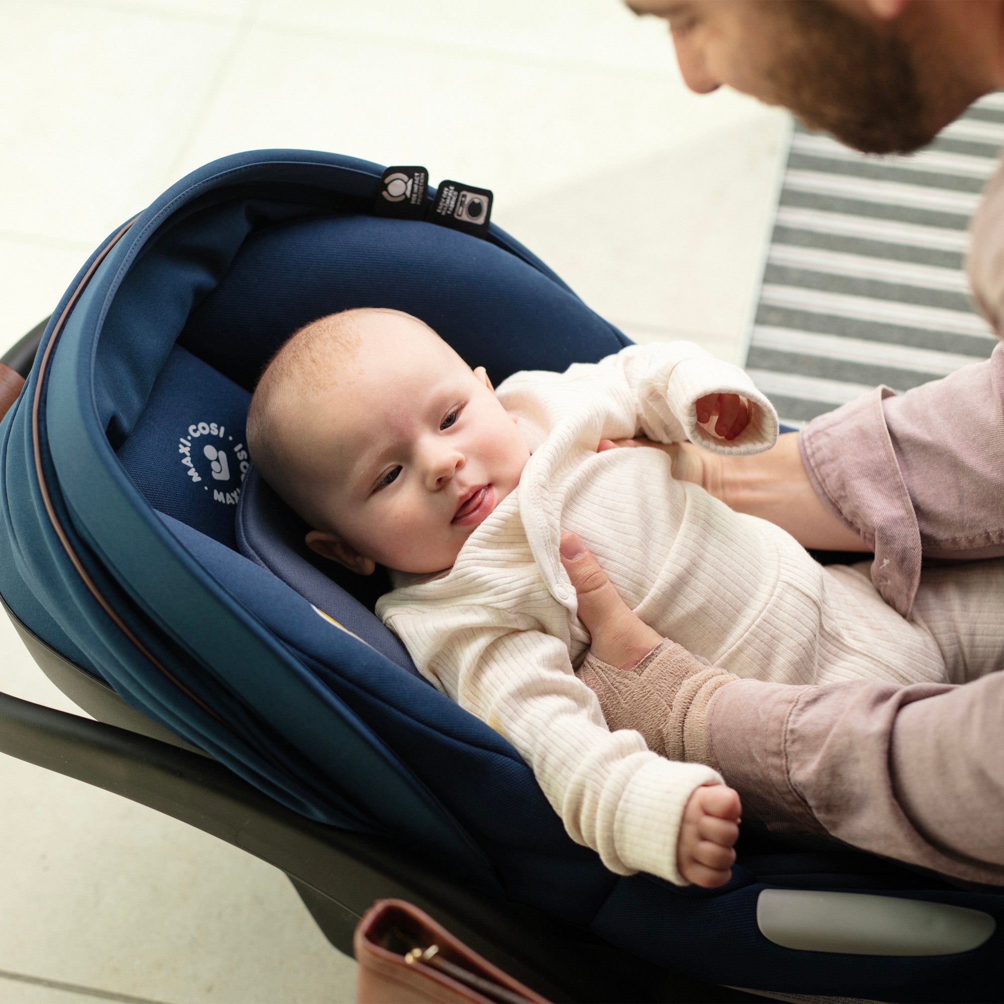 Mico™ Luxe Infant Car Seat - father taking baby out of car seat