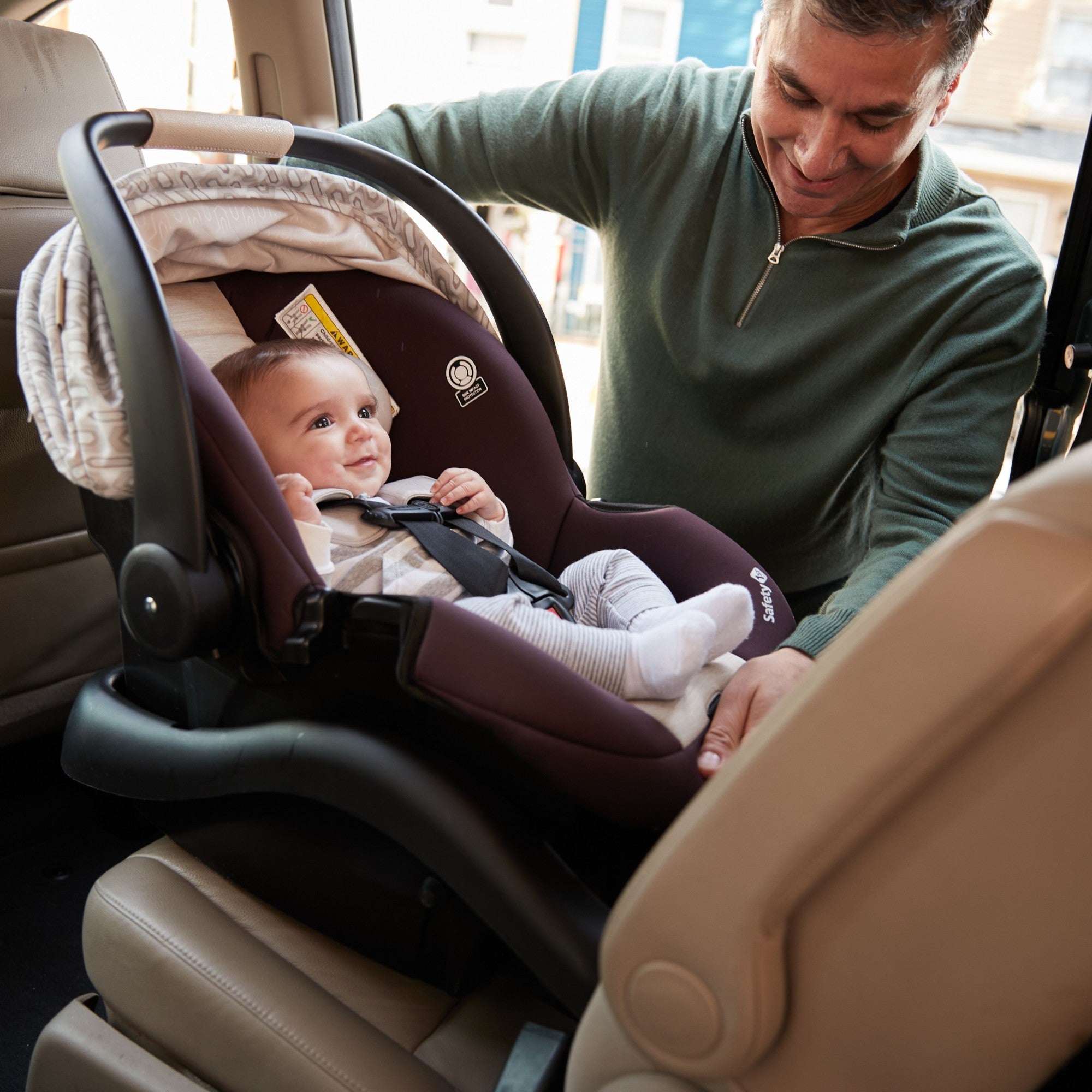 Deluxe Grow and Go™ Flex 8-in-1 Travel System - father placing baby in infant car seat in car