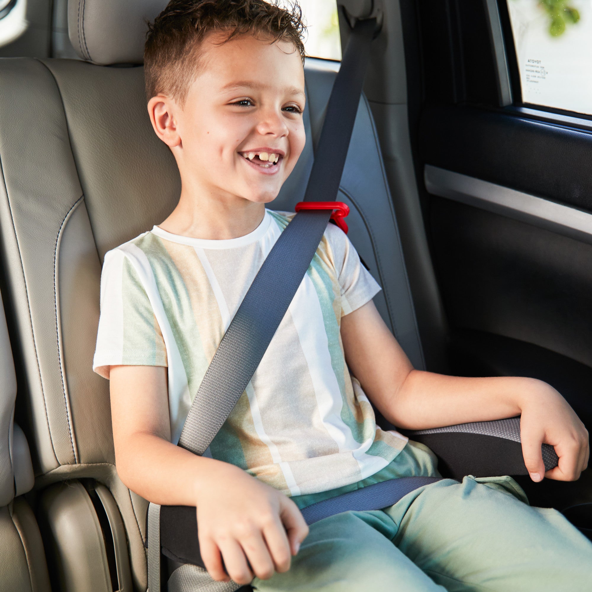 Boost-and-Go™ Lite Backless Booster - child smiling in backless booster seat
