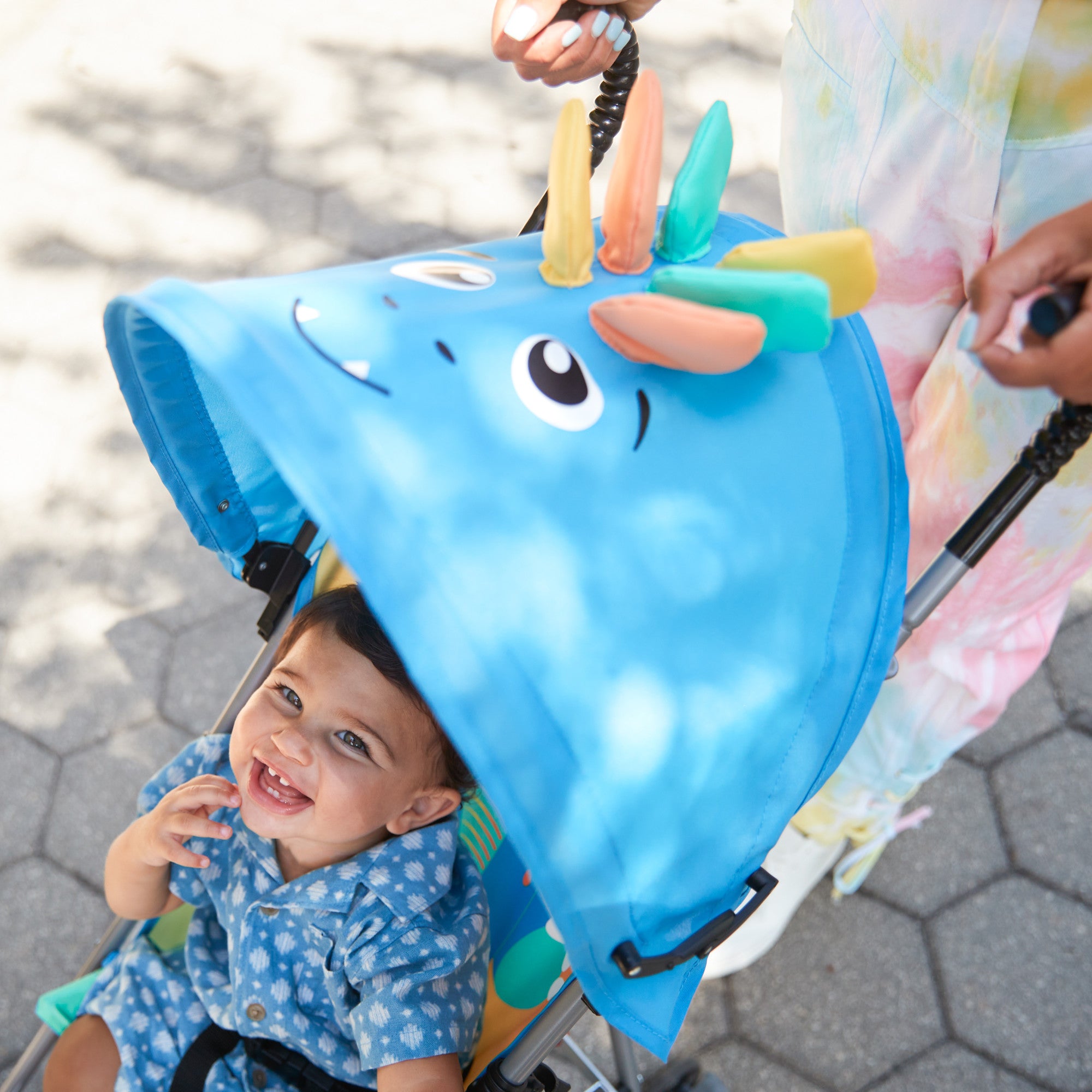 Cosco Kids™ Character Umbrella Stroller - Stewie Stegosaurus - child smiling in stroller