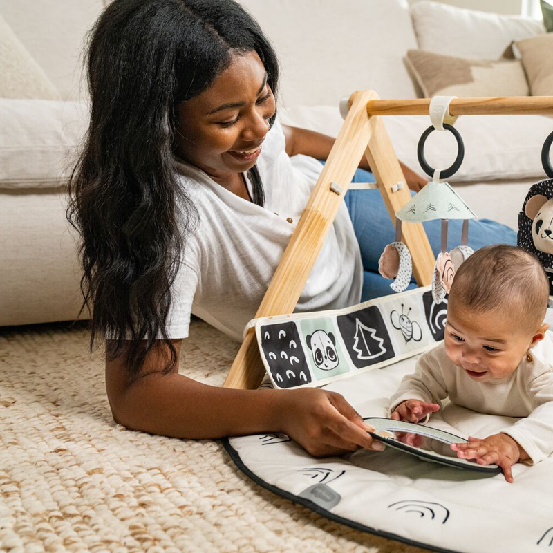 mom interacting with baby on activity mat