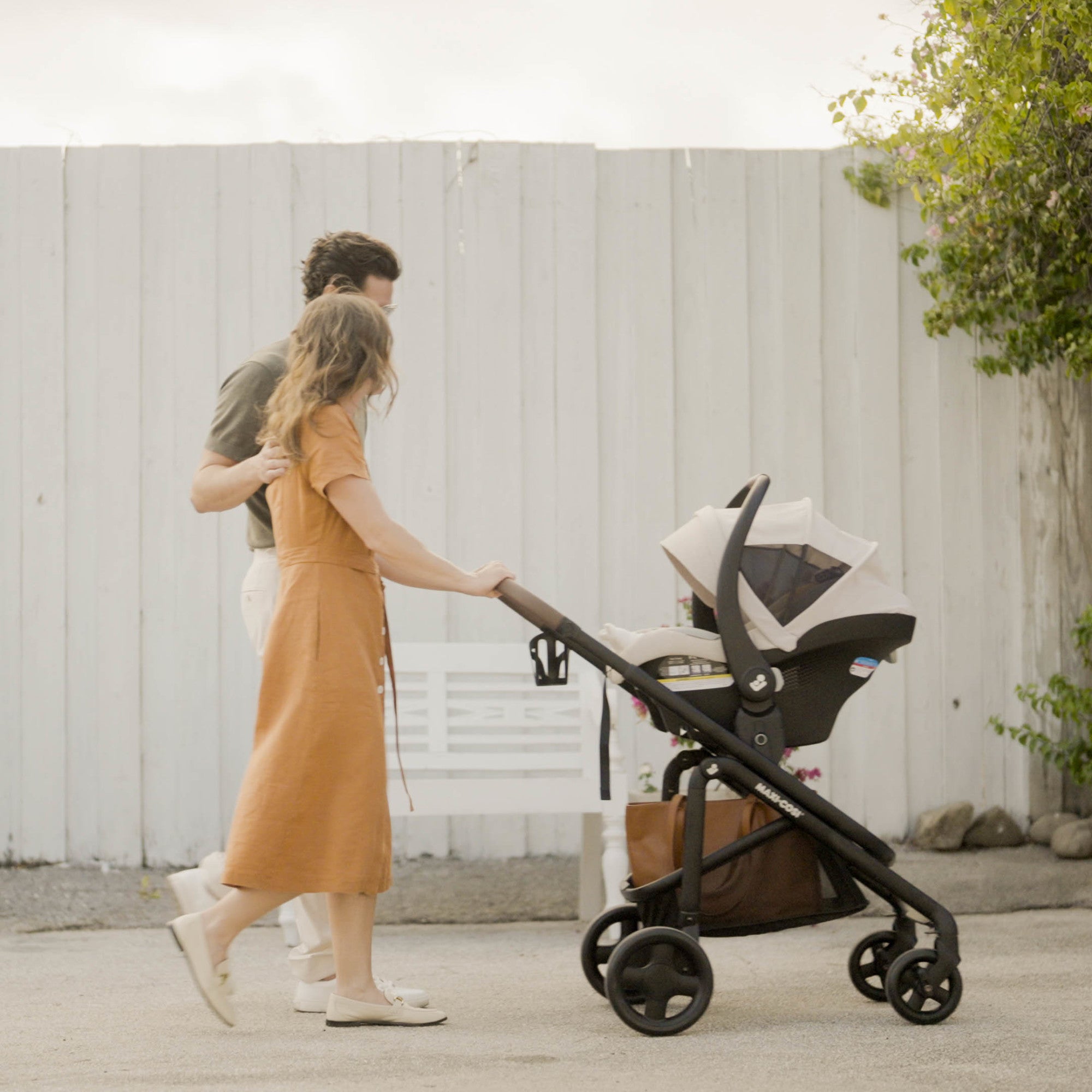 Tayla™ Max Travel System - mother and father using Tayla Max in reversible stroller mode