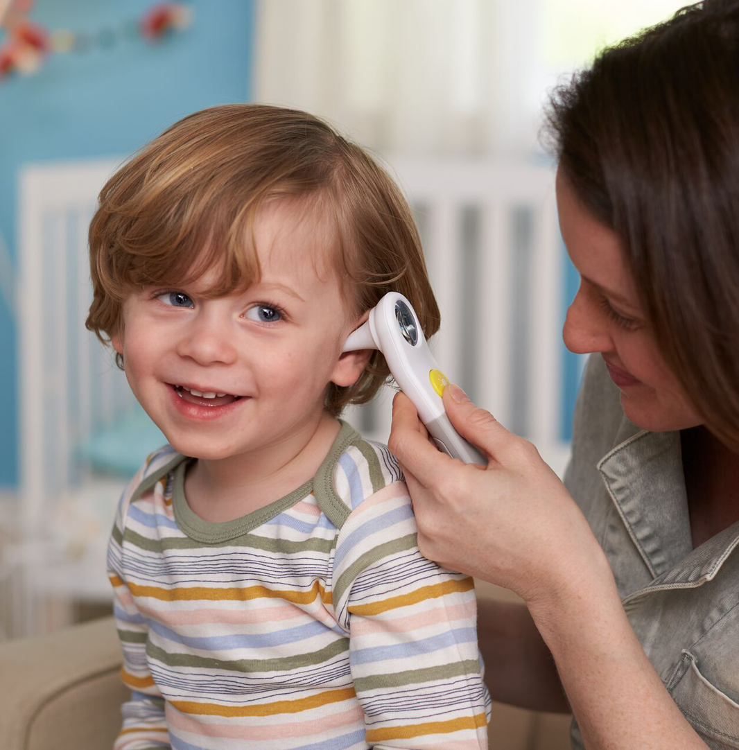 child getting ear checked with ear otoscope