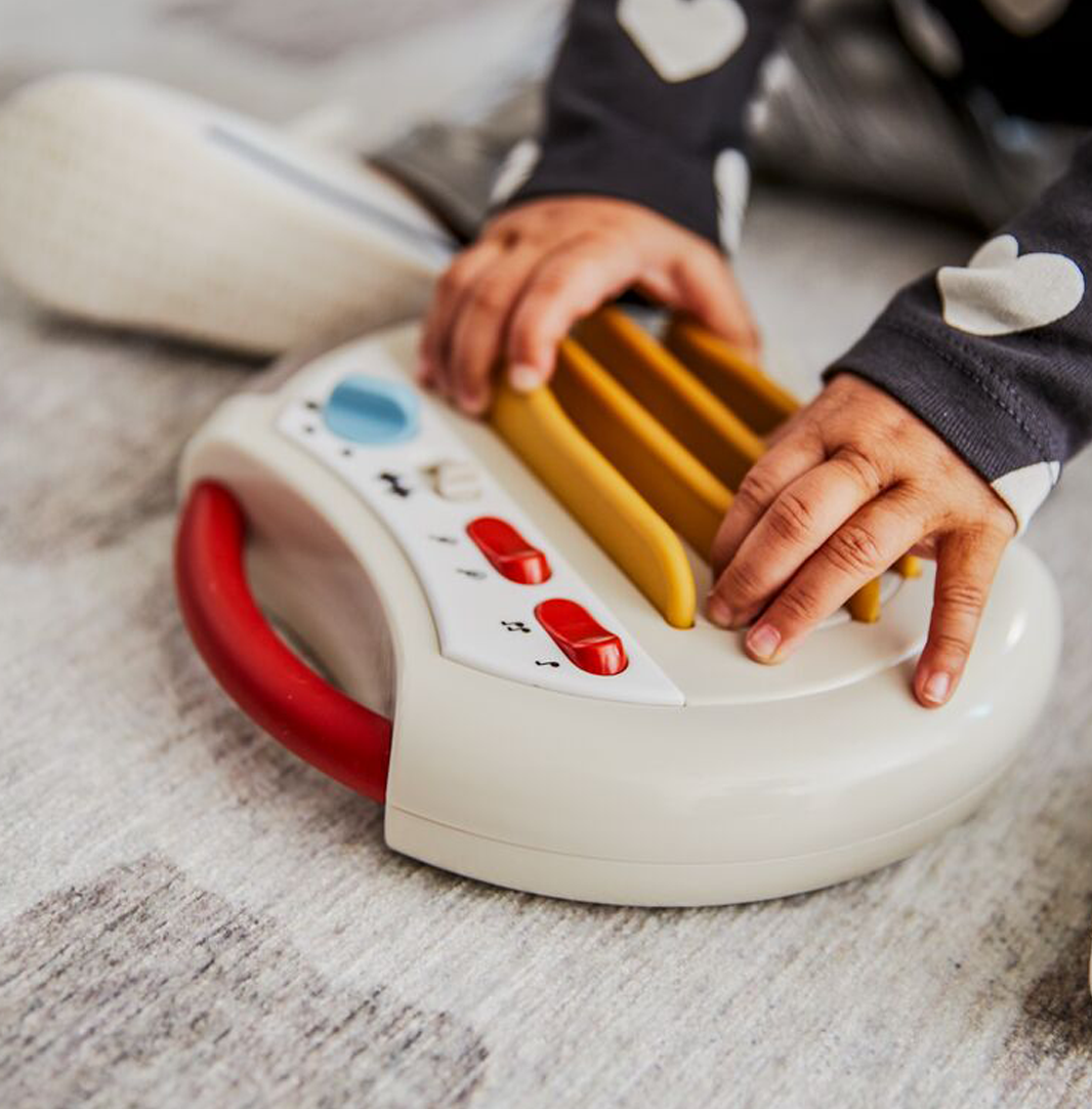 baby hands playing with musical toy