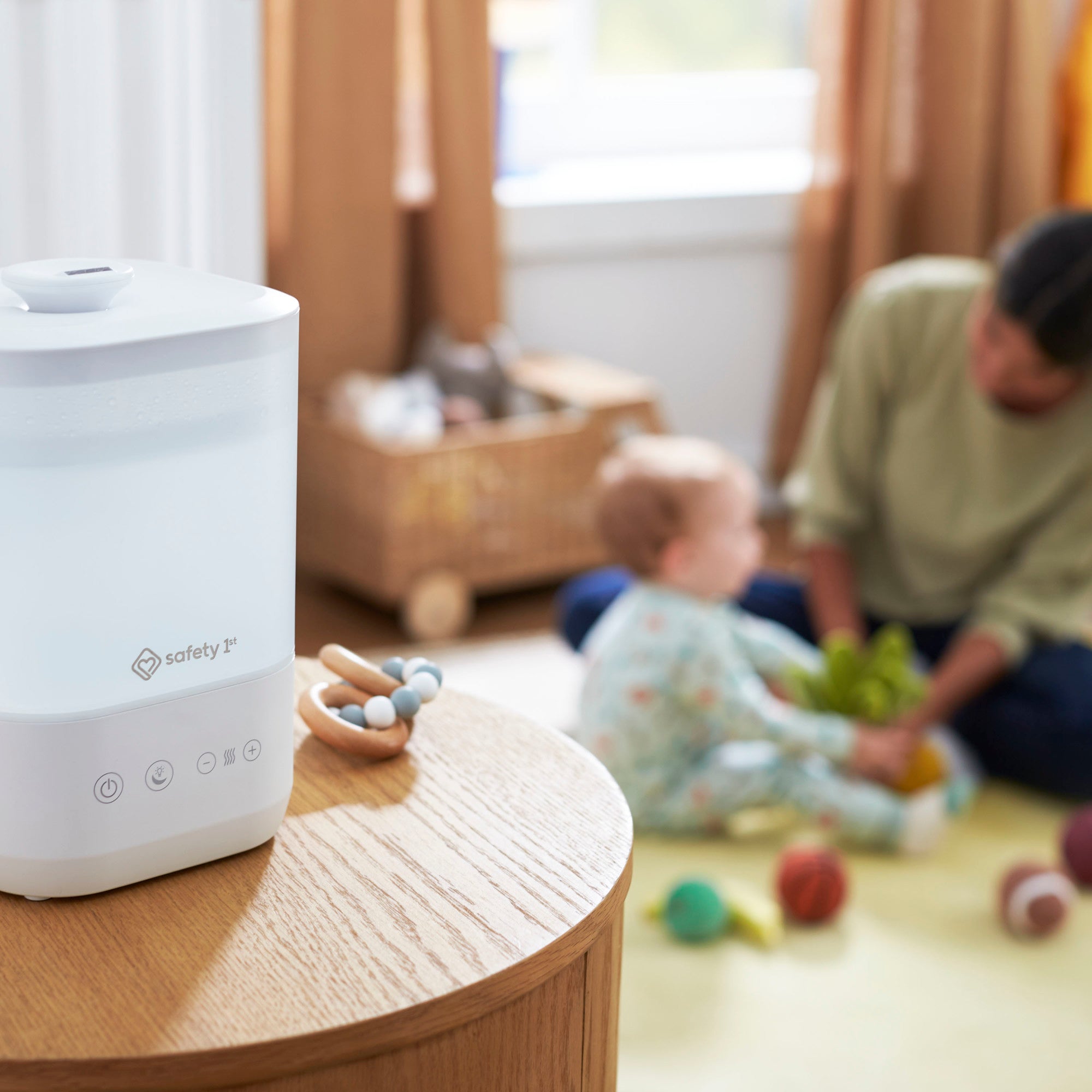 Comforting Cool Mist Top-Fill Humidifier - humidifier on nightstand as baby and mother play on the floor in background