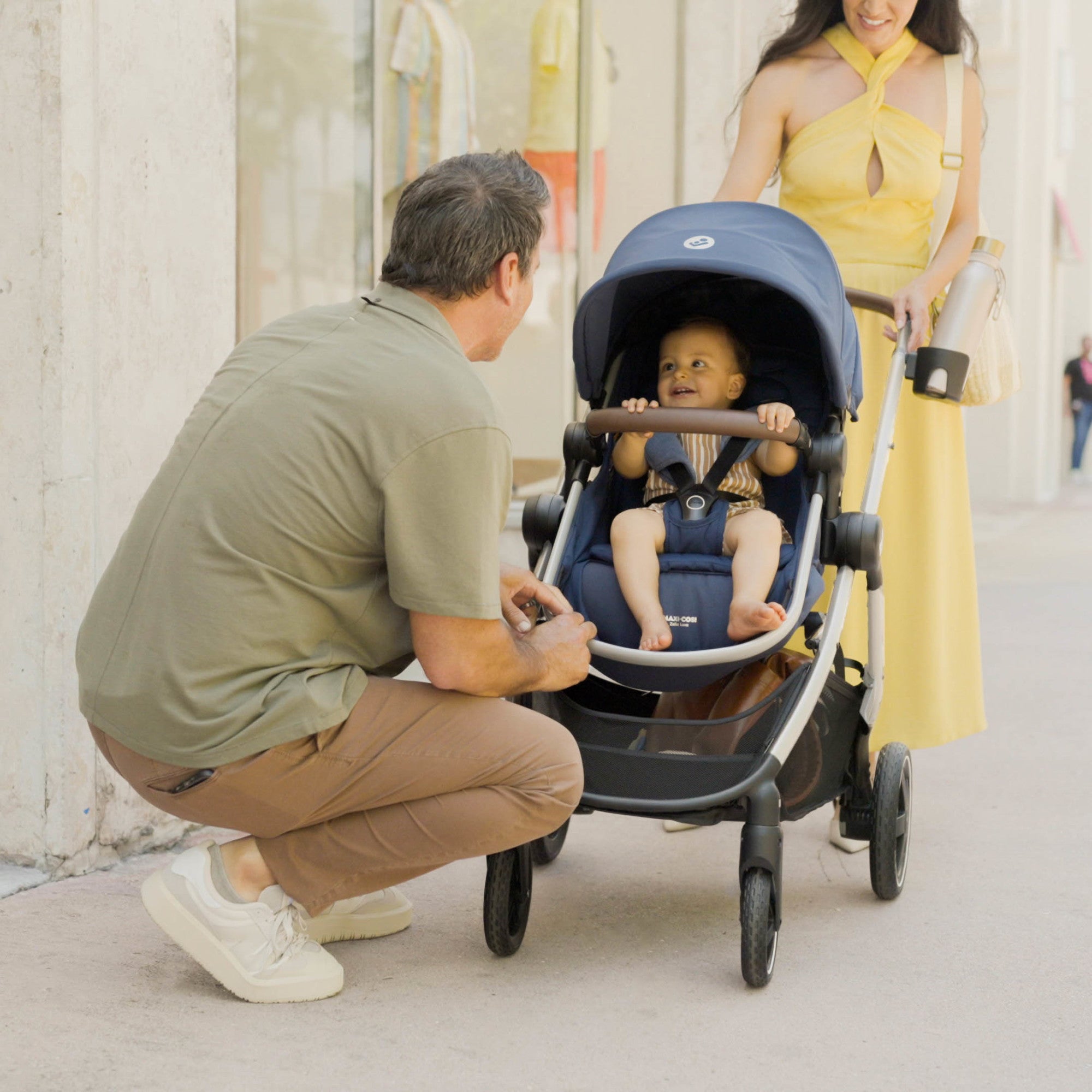 Zelia™² Luxe 5-in-1 Modular Travel System - father bending down looking at baby in stroller
