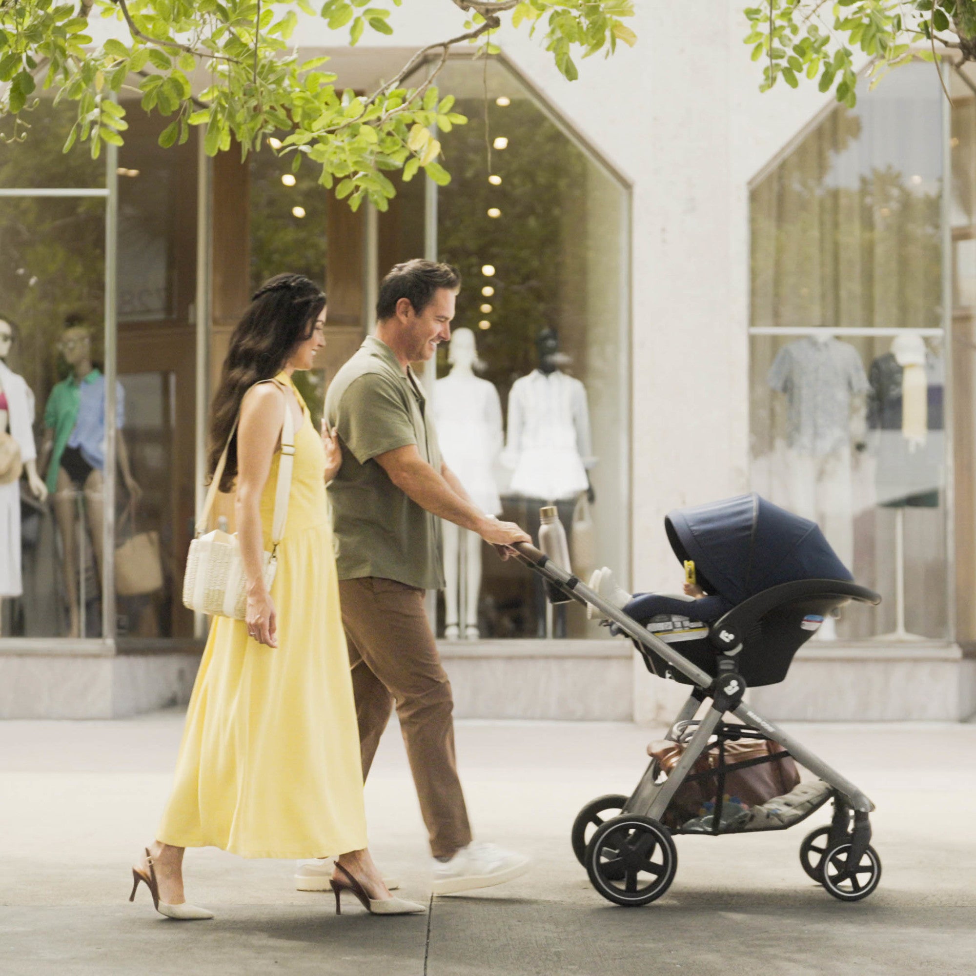 Zelia™² Luxe 5-in-1 Modular Travel System - father and mother strolling in rear-facing stroller mode